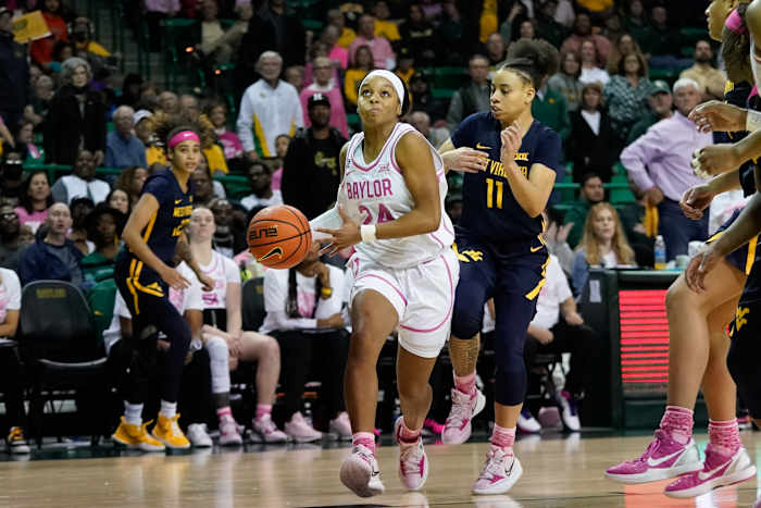 Feb 12, 2022; Waco, Texas, USA; Baylor Lady Bears guard Sarah Andrews (24) looks to score past West Virginia Mountaineers guard Ja'Naiya Quinerly (11) during the second half at Ferrell Center. Mandatory Credit: Chris Jones-USA TODAY Sports